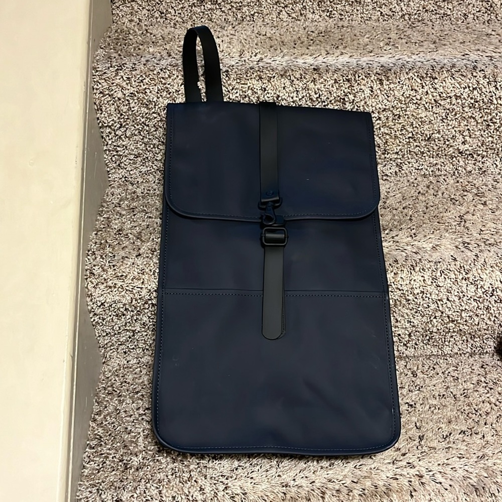 Rains navy with black leather trim backpack